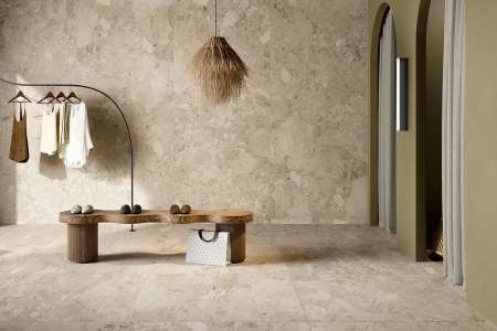 Velké béžové obklady a dlažba v převlékárně ze série Coem Sassiepietre.
