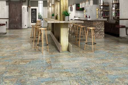 Podlaha v restauraci s velkou dekor dlažbou luxusního vzhledu ze série Aparici Carpet.