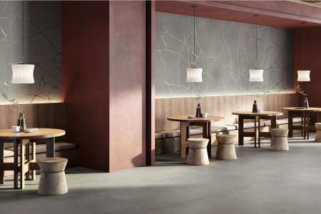 Realizace tmavě laděné restaurace Cement Effect Graphite a Metal Groove Graphite ze serie Wide Gress 280