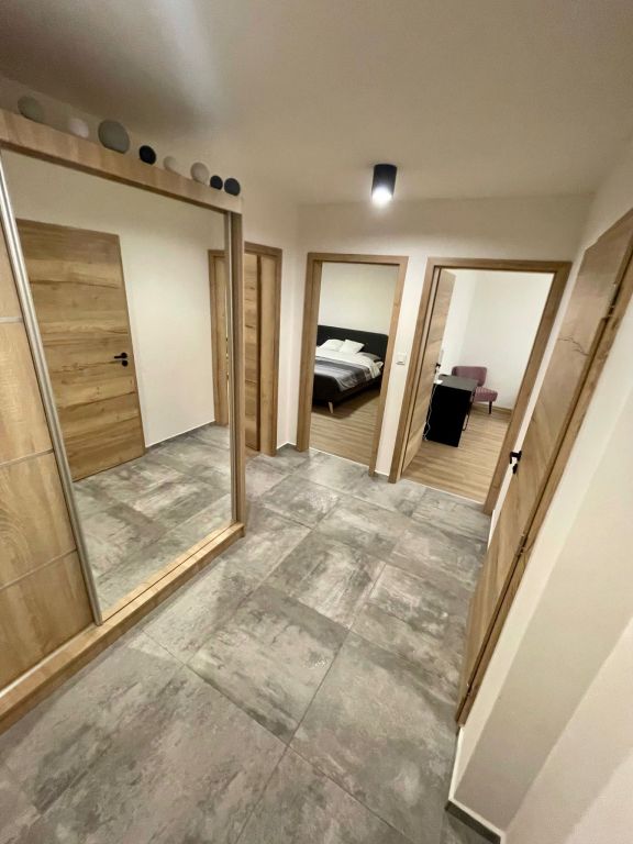 Realizace Moderní interiér bytu – světlá chodba s proměnlivou dlažbou v imitaci betonu